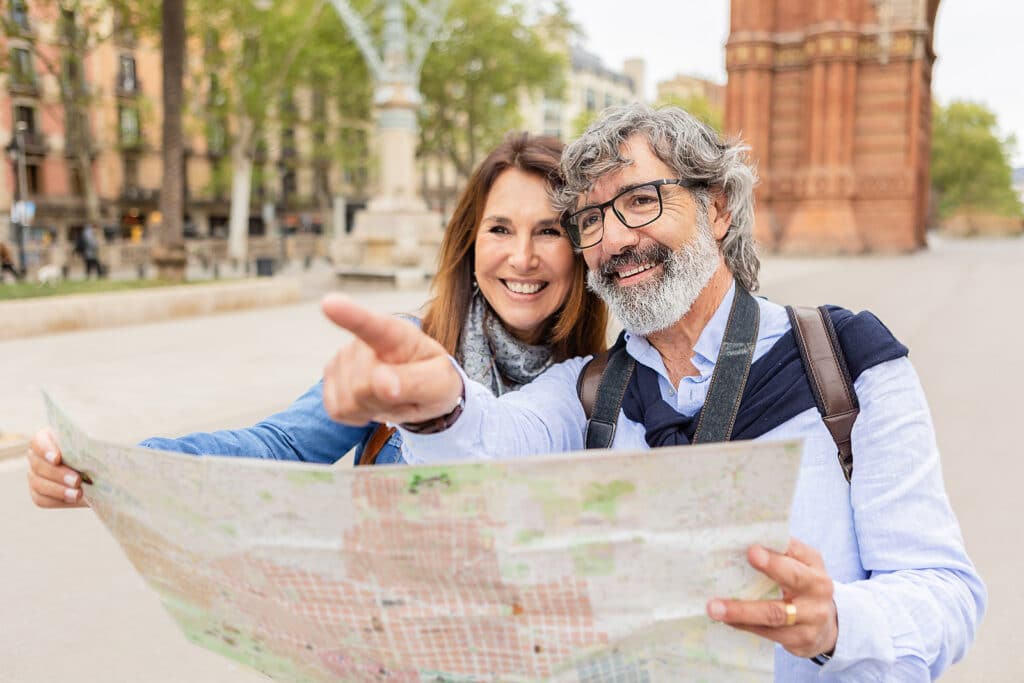 Happy Senior Adult Tourist Couple Holding City Map While Visitin